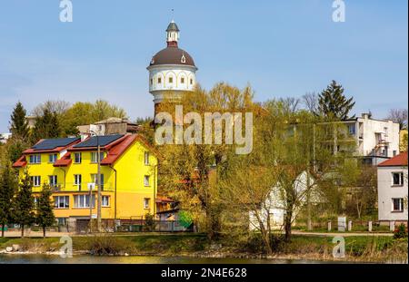 Elk, Poland - May 1, 2022: Panoramic view of Elk town center with historic water tower Wieza Cisnien at Jezioro Elckie lake shore in Masuria region Stock Photo