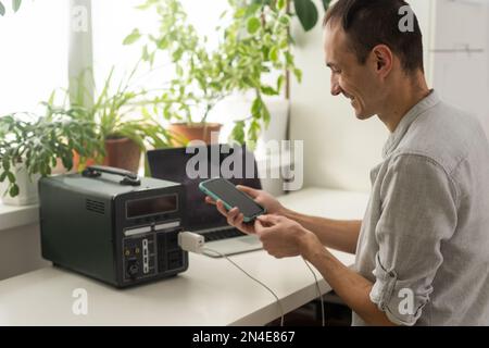 The inverter generator charges the power bank battery Stock Photo