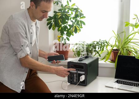 The inverter generator charges the power bank battery Stock Photo