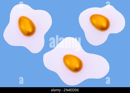 Creative layout made of scrambled eggs with decorated golden Easter eggs on a blue background. Minimal blue pattern background. Spring holidays concep Stock Photo