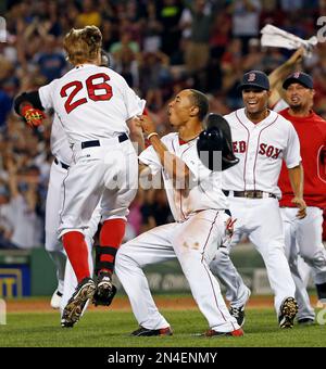 Xander Bogaerts and Brock Holt of the Boston Red Sox celebrate after