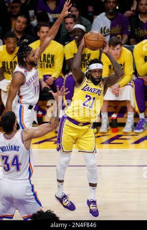 Los Angeles Lakers guard Patrick Beverley (R) passes the ball while defended by Oklahoma City Thunder guards Isaiah Joe (top L) and Kenrich Williams during an NBA basketball game.Final scores; Thunder 133:130 Lakers Stock Photo