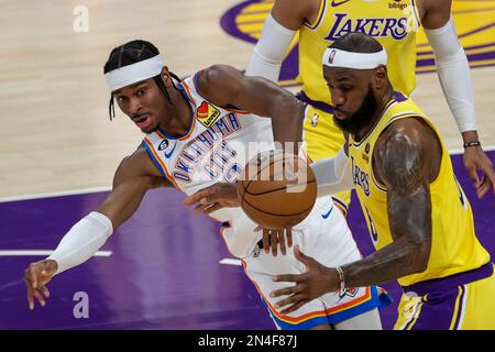 Oklahoma City Thunder guard Shai Gilgeous-Alexander (L) and Los Angeles Lakers forward LeBron James  fight for the ball during an NBA basketball game.Final scores; Thunder 133:130 Lakers Stock Photo