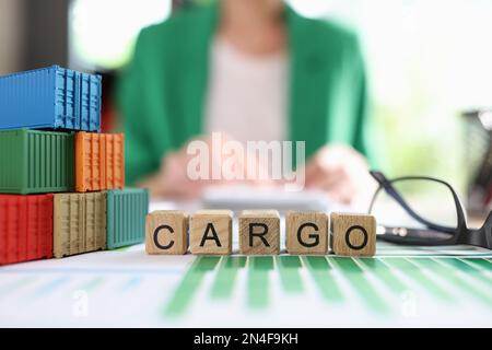 Heap of various shipping containers and word cargo collected from wooden cubes in financial report. Stock Photo