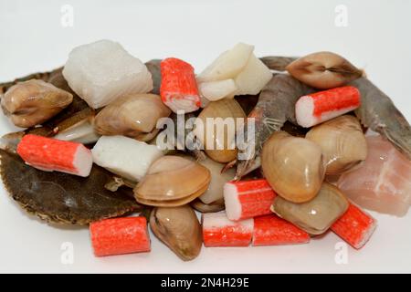 background of fresh seafood marine crabs, shrimps, clams, mussels, gandofli, oysters, crab sticks, calamari, squid and fish fillet ready to be cooked Stock Photo