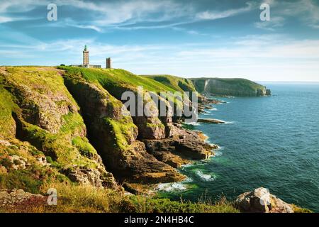 Panoramic view of scenic coastal landscape with traditional lighthouse at famous Cap Frehel peninsula on the Cote d'Emeraude, commune of Plevenon, Cot Stock Photo