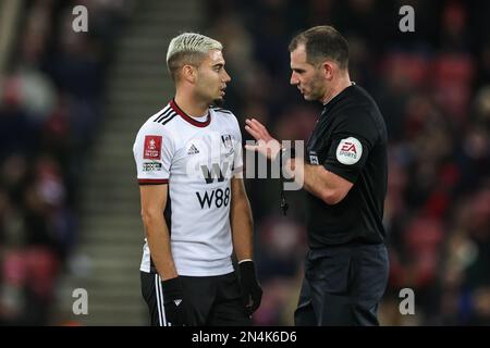 Referee Tim Robinson speaks to Andreas Pereira #18 of Fulham during the Emirates FA Cup fourth round replay match Sunderland vs Fulham at Stadium Of Light, Sunderland, United Kingdom, 8th February 2023  (Photo by Mark Cosgrove/News Images) Stock Photo