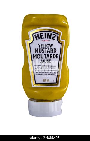 A squeezy bottle of Yellow Mustard sold in Canada by Heinz.  With a bilingual label. Stock Photo