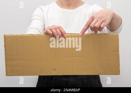 Woman in hands with a blank cardboard. mockup for agenda or  activity information. Stock Photo