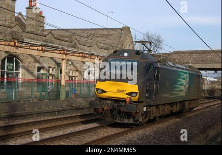 Direct Rail Services class 88 electro-diesel loco, 88007 Electra, running light engine on West Coast Main Line through Carnforth on 8th February 2023. Stock Photo