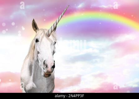 Magic unicorn in beautiful sky with rainbow and fluffy clouds. Fantasy ...