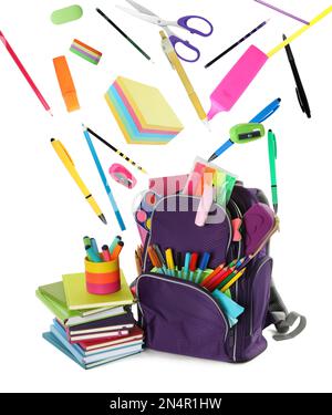 School stationery flying over backpack on white background Stock Photo