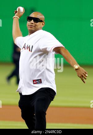 Former MLB pitchers Livan Hernandez, left, and his half-brother Orlando   El Duque Hernandez, right, chat with Jacob Forever, former member of the  Cuban reggaeton group Gente de Zona, after throwing out