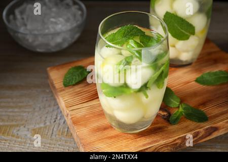 Tasty melon ball drink on wooden table, closeup Stock Photo