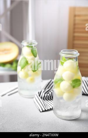 Tasty melon ball drink on light grey table indoors Stock Photo