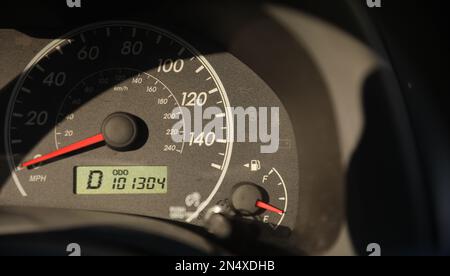 Car speedometer in sunlight with gas showing Stock Photo