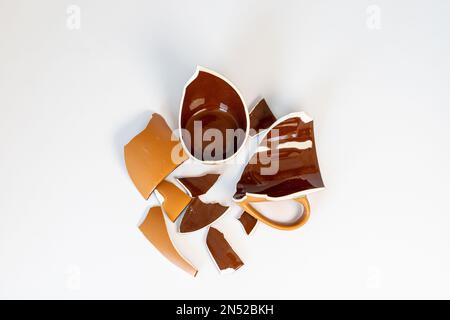Broken coffee cup on white background Stock Photo