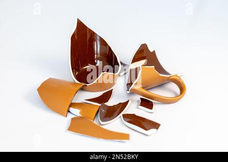 Broken tea cup isolated on white background Stock Photo