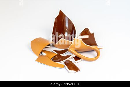 Broken earthenware pieces isolated on white background Stock Photo