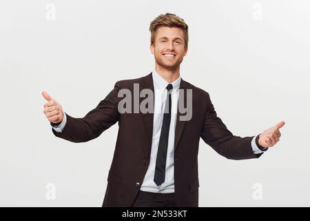 Style is second nature for me. Studio portrait of a stylishly-dressed young businessman giving two thumbs up to the camera. Stock Photo