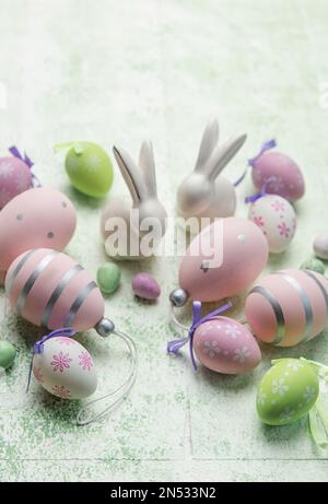 Decorative rabbits and  Easter eggs on the table. The concept of Easter holidays. Stock Photo