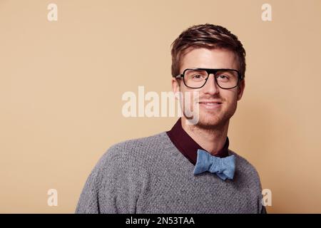 Looking stylish and I know it. Studio portrait of a stylishly-dressed young man smiling at the camera. Stock Photo