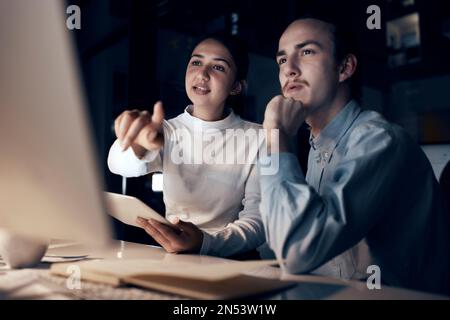 Computer, teamwork and people night office for information technology, programming and software development. Programmer, coding and cybersecurity Stock Photo