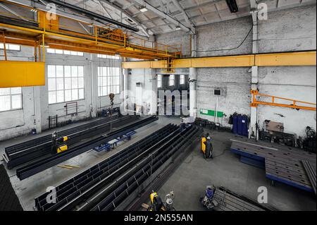 Long steel constructions assembling with welding in workshop Stock Photo