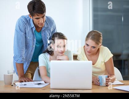 Giving their input. three colleagues working in an office. Stock Photo