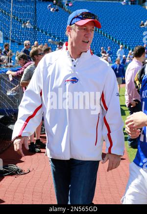 Buffalo Bills quarterback Jim Kelly, right, with Bills owner Ralph Wilson,  Jr. pose with a jersey during a press conference in Buffalo, New York on  August 18, 1986. Photo by Francis Specker