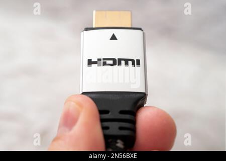 hdmi high definition multimedia interface on hand. High-speed 8K signal transmission. HDMI connector Stock Photo