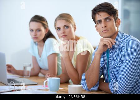 Ideas on the brain. three colleagues working in an office. Stock Photo