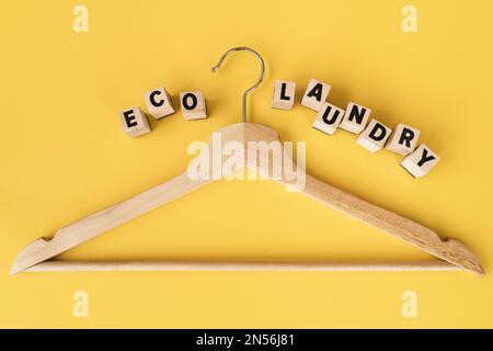 top view wooden hanger with yellow background. Resolution and high quality beautiful photo Stock Photo