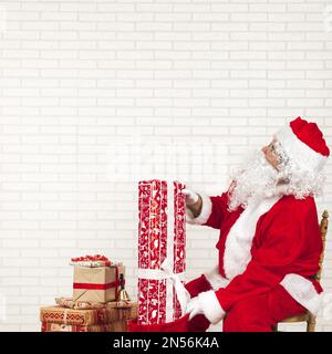 santa claus putting presents bag . Resolution and high quality beautiful photo Stock Photo