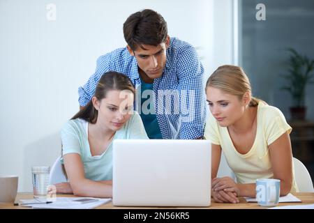 Brainstorming. three colleagues working in an office. Stock Photo