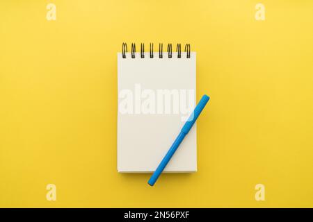notepad with pen yellow background. Resolution and high quality beautiful photo Stock Photo