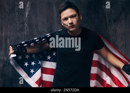 Tattooed guy with US flag on dark background Stock Photo