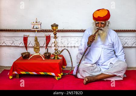 Water pipe smoker at Meherangarh Fort, Jodpur, Jodpur, Rajasthan, India Stock Photo
