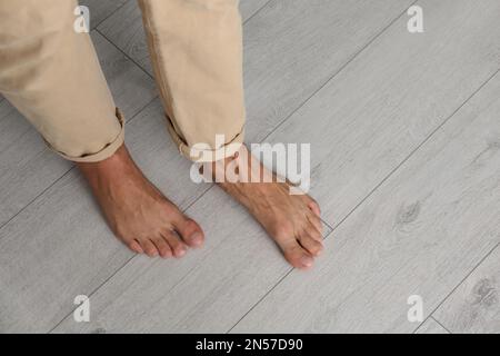 Man walking barefoot at home, closeup. Floor heating concept Stock Photo
