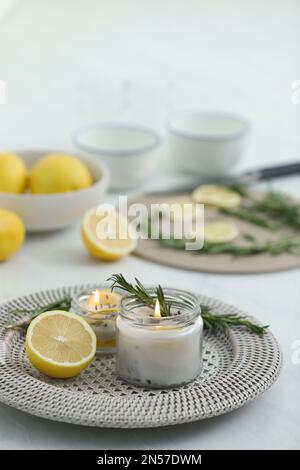 Natural homemade mosquito repellent candle and ingredients on white table Stock Photo