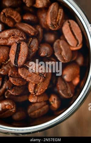 Closeup Roasted coffee beans in Coffee Machine Filter Stock Photo