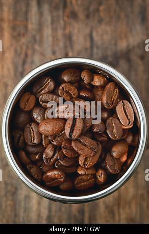 Closeup Roasted coffee beans in Coffee Machine Filter Stock Photo