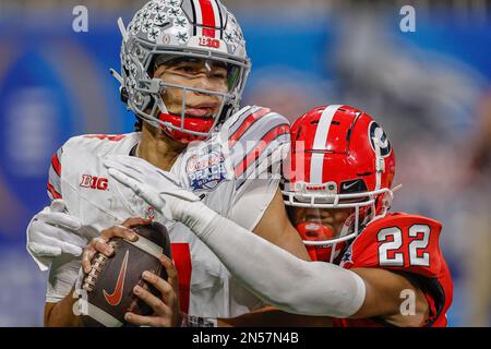 December 31, 2022: Ohio State's CJ Stroud (7) is hit and taken down for a sack by Georgia's Javon Bullard (22) during the Chick-fil-A Peach Bowl (a College Football Playoff Semifinal) featuring the #4 Ohio State Buckeyes and the #1 Georgia Bulldogs, played at Mercedes-Benz Stadium in Atlanta, Georgia. The Georgia Bulldogs come from behind to defeat Ohio State, 42-41. Cecil Copeland/MarinMedia.org/CSM Stock Photo