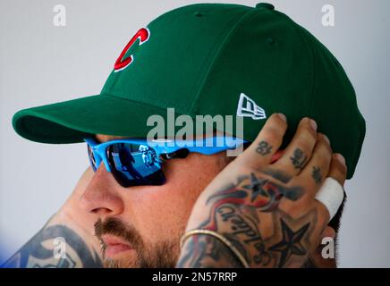 A Chicago Cubs spring training cap sits on the bench during the