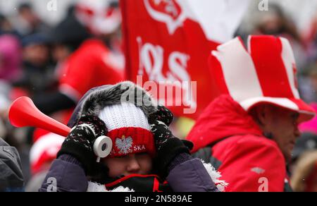 A young Poland fan waits for the start of the Ski Flying World Championships as the trial round was canceled due to the strong wind in Harrachov, Czech Republic, Saturday, March 15, 2014. (AP Photo/Petr David Josek)
