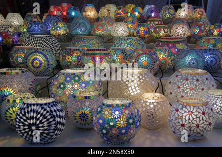 Table lamps decorated with mosaics of various colors for sale in a street market Stock Photo