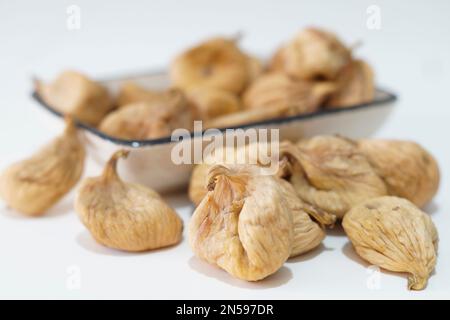 Dried figs in plate isolated on white Stock Photo