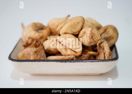 Dried figs in plate isolated on white Stock Photo