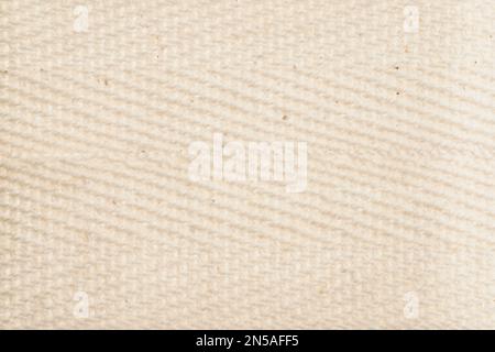Natural cream light fiber texture background. Macro photography of large weave cotton hemp and linen material Stock Photo