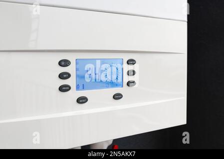 Close up of smart control panel of gas boiler for winter home heating and hot water. Modern house device Stock Photo